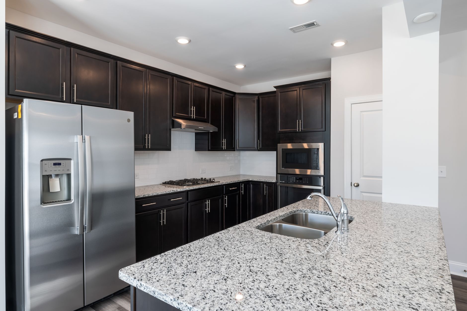Sleek kitchen design featuring granite countertops and stainless steel appliances